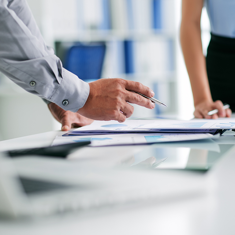 Closeup of hands over documents at a business meeting