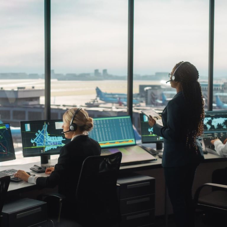 Air traffic control team working in airport tower