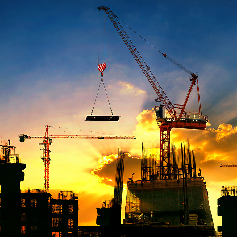 big crane and building construction against beautiful dusky sky use for construction industry and engineering