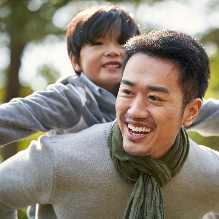 Father and son piggyback bonding