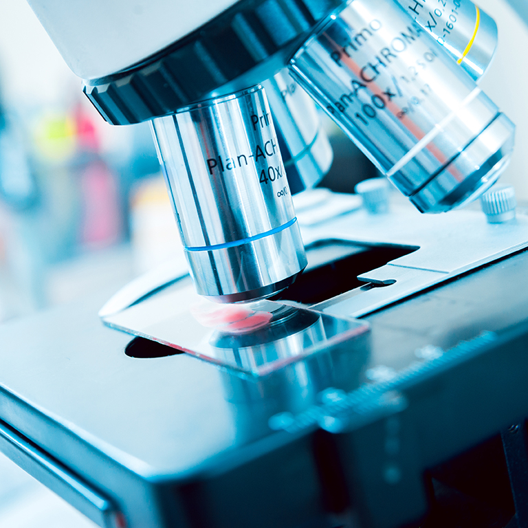 Close up of a microscope examining a glass slide specimen. Medical equipment. microscope. Background