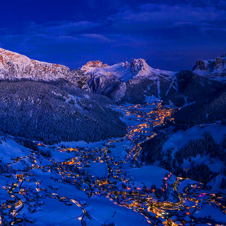 Panoramic view of Dolomites mountains at dusk during winter time
