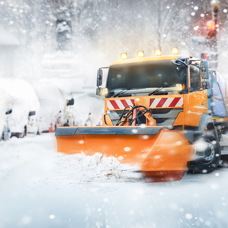 Professional snow cleaning - snow plow in the city