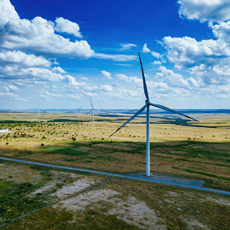 Wind turbines at the countryside in summer day, aerial view.